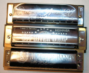 Three Hohner harmonicas